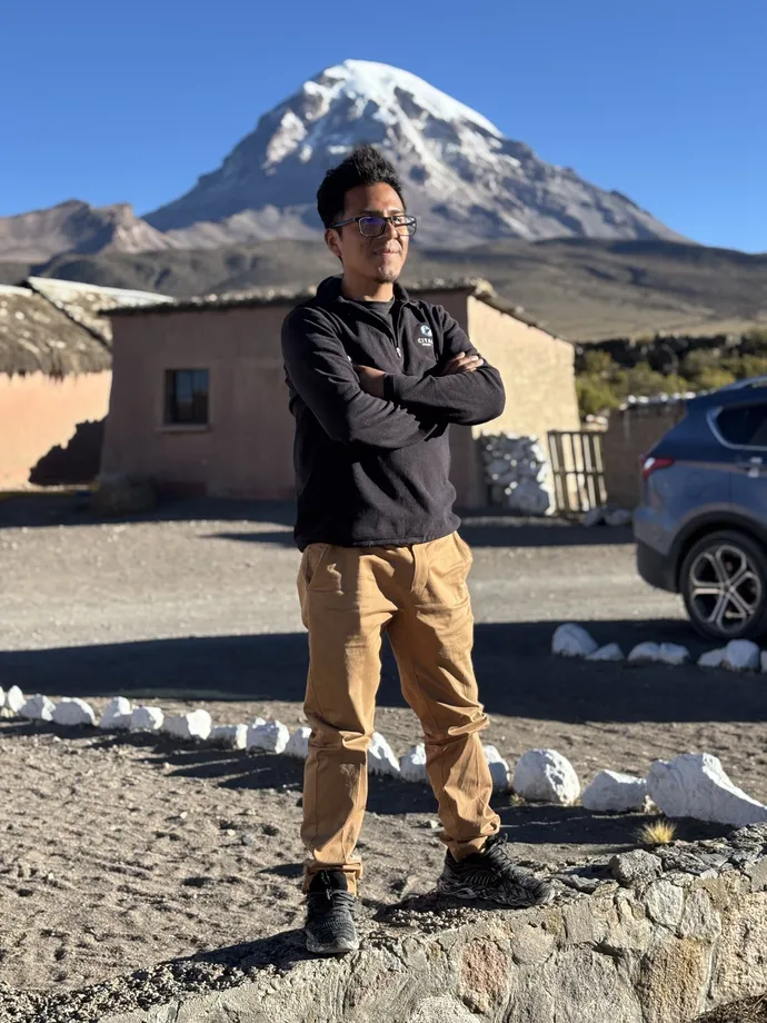 Richard Martínez, Fat Cat driver, standing in front of the Sajama volcano