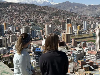 Travelers at a viewpoint over the bowl of La Paz