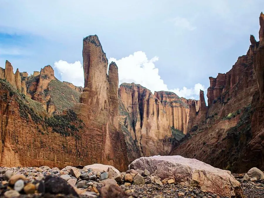 Palca Canyon: red rock walls and towers above the dry riverbed