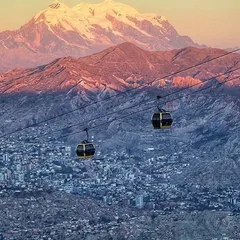 A cable car over La Paz with the Illimani at sunset
