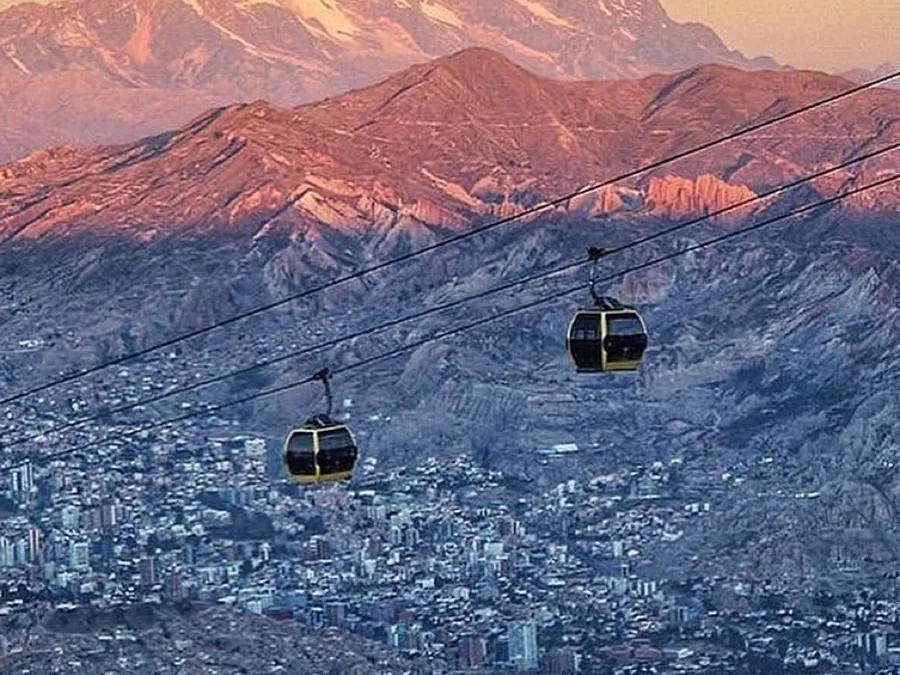 A cable car over La Paz with the Illimani at sunset
