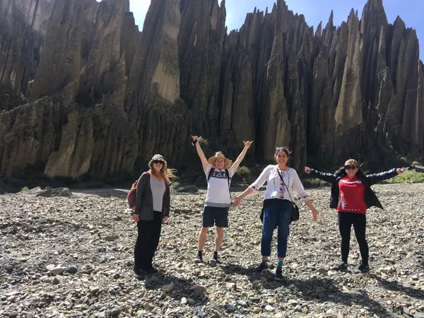 A group in the riverbed, arms up