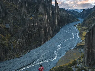 The riverbed of Valle de las Ánimas from the ridge, early light on the spires